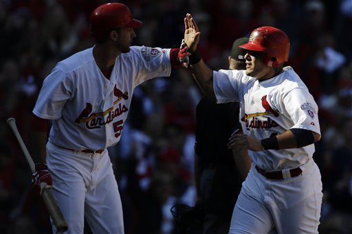 Molina gets congratulated by Adam Wainwright after scoring on wild pitch in 2012 NLDS game vs. Nationals
